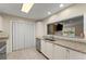 Bright kitchen with granite counters, stainless steel appliances and a pass-through window to the living area at 208 Bainbridge Dr, Atlanta, GA 30327