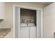 Convenient laundry closet with shelving, located near the kitchen, offering functionality and storage at 208 Bainbridge Dr, Atlanta, GA 30327