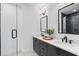 Bright bathroom featuring double vanity with white countertops, dark fixtures, and glass enclosed shower at 946 Hughley Circle # 98, Atlanta, GA 30316