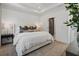 Spacious main bedroom with a contemporary design, featuring hardwood floors, stylish decor, and a view into bathroom at 946 Hughley Circle # 98, Atlanta, GA 30316