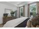 Serene main bedroom with large windows, tray ceilings, and tasteful decor, creating a peaceful retreat at 946 Hughley Circle # 98, Atlanta, GA 30316
