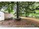 Backyard features a large shade tree with unique platform seating and storage shed at , Tucker, GA 30084