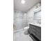 Modern bathroom features white marble tile, glass enclosed shower, and vanity with drawers at , Tucker, GA 30084