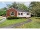 Well-maintained home with light siding, brick accents, and a sidewalk leading to the front door at , Tucker, GA 30084