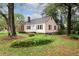 A charming home showcasing a well-manicured lawn and mature trees against a blue sky at , Tucker, GA 30084