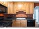 This kitchen features light wood cabinets, black appliances and plenty of counter space at , Tucker, GA 30084
