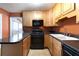 A well-lit kitchen showcasing light wood cabinets and modern black appliances at , Tucker, GA 30084