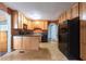Traditional kitchen with light wood cabinets and black appliances offering ample counter space at , Tucker, GA 30084