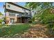 Expansive backyard with a wood deck, brick patio, and mature landscaping at 1151 Goodwin Ne Rd, Brookhaven, GA 30324