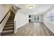Finished basement with vinyl floors, stairs to the main floor, and a doorway to a partial kitchen at 1151 Goodwin Ne Rd, Brookhaven, GA 30324
