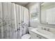 Neutral bathroom with white vanity, shower-tub combo, and floral shower curtain at 1151 Goodwin Ne Rd, Brookhaven, GA 30324