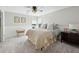 Cozy bedroom with gray carpet, ceiling fan, a double window, and a quilted bedspread at 1151 Goodwin Ne Rd, Brookhaven, GA 30324