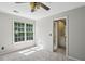 Bedroom with carpet, a large window with natural light, and a glimpse of the en-suite bathroom at 1151 Goodwin Ne Rd, Brookhaven, GA 30324
