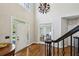 Bright foyer featuring hardwood floors, double entry doors, and staircase with wrought iron railing at 1151 Goodwin Ne Rd, Brookhaven, GA 30324