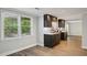 Basement kitchenette with shaker cabinets, granite counters, and vinyl floors near a window at 1151 Goodwin Ne Rd, Brookhaven, GA 30324