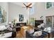 Spacious living room with high ceilings, fan, many windows, fireplace, and comfortable seating at 1151 Goodwin Ne Rd, Brookhaven, GA 30324