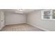 Neutral carpeted room with recessed lighting, window with blinds, and white trim at 1151 Goodwin Ne Rd, Brookhaven, GA 30324