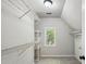 Bright walk-in closet with built-in shelving and natural light at 1151 Goodwin Ne Rd, Brookhaven, GA 30324