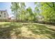 Expansive backyard with a wooden fence, and a fire pit, ideal for outdoor entertaining at 1356 Belfaire Trce, Dacula, GA 30019