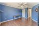 Cozy bedroom featuring hardwood floors, a ceiling fan and nautical themed wallpaper at 1356 Belfaire Trce, Dacula, GA 30019