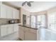 Bright kitchen boasts a granite-topped island, modern cabinetry, and natural light from the door to the deck at 1356 Belfaire Trce, Dacula, GA 30019