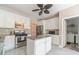 Well-lit kitchen features a granite-topped island, stainless steel appliances, and ample counter space at 1356 Belfaire Trce, Dacula, GA 30019