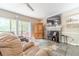 Comfortable living room with a fireplace, large windows, tile flooring, and neutral-colored furniture at 1356 Belfaire Trce, Dacula, GA 30019