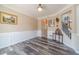 Inviting living room featuring wainscotting, wood floors, and natural light at 1356 Belfaire Trce, Dacula, GA 30019