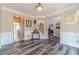 A bright living room with wood floors, wainscotting, and views of the staircase at 1356 Belfaire Trce, Dacula, GA 30019