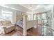 Sun-filled main bedroom with hardwood floors, tray ceiling, and large windows at 1356 Belfaire Trce, Dacula, GA 30019