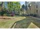 Serene backyard with landscaped yard, mature trees, and a relaxing deck area at 1420 Lockridge Dr, Cumming, GA 30041