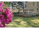 Backyard featuring a large deck, well-manicured lawn, and vibrant floral bushes at 1420 Lockridge Dr, Cumming, GA 30041