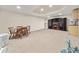 Spacious basement area includes a dining set, fireplace, and entertainment center at 1420 Lockridge Dr, Cumming, GA 30041