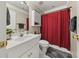 Bathroom featuring a single vanity sink and a shower with a red plaid curtain at 1420 Lockridge Dr, Cumming, GA 30041