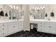 Elegant bathroom featuring a double vanity, stylish mirrors, and black tile floors at 1420 Lockridge Dr, Cumming, GA 30041