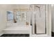Bathroom showcasing a soaking tub and glass-enclosed shower at 1420 Lockridge Dr, Cumming, GA 30041