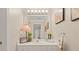 Bathroom featuring a large mirror, stylish lighting, and vanity with decorative accessories at 1420 Lockridge Dr, Cumming, GA 30041