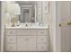 Bright bathroom featuring a white vanity with marble countertops and a decorative mirror at 1420 Lockridge Dr, Cumming, GA 30041