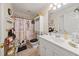 Bathroom with a decorative shower curtain, vanity, and ample storage at 1420 Lockridge Dr, Cumming, GA 30041