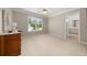 Bright bedroom featuring a window, carpeted floors, and access to the bathroom at 1420 Lockridge Dr, Cumming, GA 30041