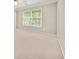 Bright bedroom featuring a window and carpeted floors at 1420 Lockridge Dr, Cumming, GA 30041