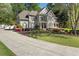 Charming two-story home with manicured landscaping, a well-kept lawn and a long driveway leading up to the house at 1420 Lockridge Dr, Cumming, GA 30041