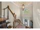 Foyer features wood staircase, chandelier, and decorative front door at 1420 Lockridge Dr, Cumming, GA 30041