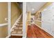 Hallway with hardwood floors, staircase, and decorated walls, leading to a doorway at 1420 Lockridge Dr, Cumming, GA 30041