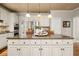 Kitchen island features granite countertops, pendant lighting and cabinet storage at 1420 Lockridge Dr, Cumming, GA 30041
