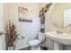 Charming half bathroom featuring a modern vanity, decorative mirror, and elegant decor at 2142 Theberton Trl, Locust Grove, GA 30248