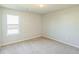 Bright, carpeted bedroom with natural light, neutral walls, and ample space for furniture at 2142 Theberton Trl, Locust Grove, GA 30248