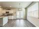 Dining area adjacent to kitchen featuring hardwood floors, access to the backyard, and bright natural light at 2142 Theberton Trl, Locust Grove, GA 30248