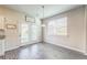 Cozy dining area with wood-look floors, modern lighting, and a view of the backyard through sliding glass doors at 2142 Theberton Trl, Locust Grove, GA 30248