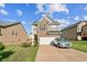 Charming two-story home features brick and siding, a well-maintained lawn, and an attached two-car garage at 2142 Theberton Trl, Locust Grove, GA 30248